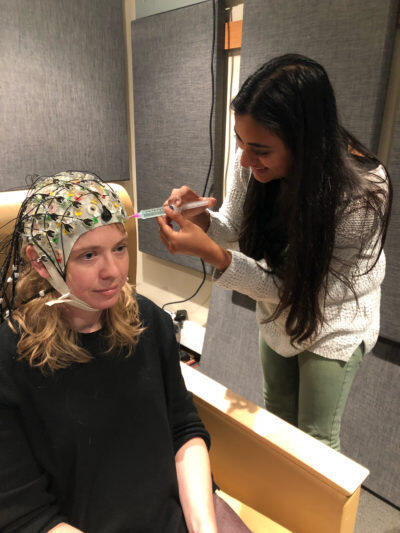 Hamilton (left) piloting an EEG study in her lab at UT Austin with graduate student Maansi Desai.