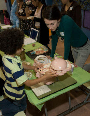 Cooper as a graduate student in 2008 volunteering at Mind & Brain Night, an after school educational event organized by HWNI PhD students.